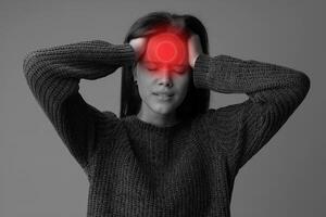 Young woman experiencing severe headache in a minimalistic indoor setting during daylight hours photo