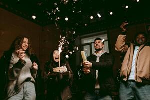 Friends celebrating a birthday with cake, sparkles, and joyful expressions in an indoor party setting photo
