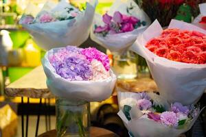 Colorful flower bouquets displayed in a vibrant shop during the daytime with bright lighting photo