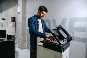 Man using a multifunction printer in a modern office setting during a productive workday photo