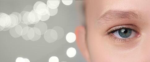 Close-up of a person's eye highlighting unique features and colorful iris against a soft backdrop of blurred lights in a serene setting photo