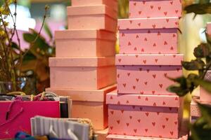 Display of decorative gift boxes arranged in a retail setting during the holiday season photo