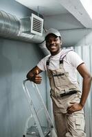 Skilled worker proudly completing installation in a modern building during daylight hours photo