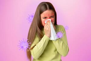 Young girl experiencing cold symptoms with a tissue against a colorful background photo