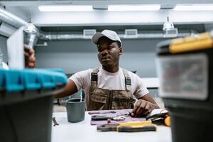 Skilled worker organizing tools in a workshop during daytime in a modern workspace photo