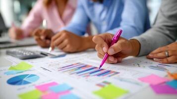 Team members collaborate on marketing strategies with colorful charts and notes in a modern office setting photo