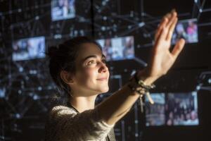 Engaging with technology in an interactive display during a digital exhibition at an urban center photo
