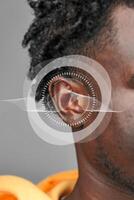Exploring the intricacies of sound perception through a close-up of an ear with sound wave graphics photo
