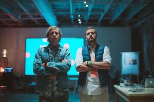 Two men stand confidently during a technology event showcasing innovative designs in a modern venue photo