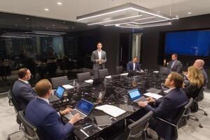 Business meeting takes place in modern conference room with professionals discussing strategy and progress in vibrant city setting photo