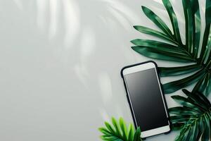 Top view of smartphone with palm leaves on white background photo