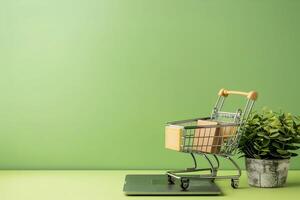 Shopping cart on laptop and green background photo
