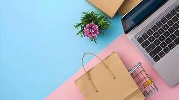 Shopping cart and laptop on pink and blue background photo