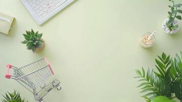 Top view of shopping cart with laptop and plants on a green background photo