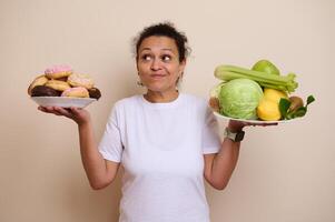 Woman Contemplating Between Sweet Doughnuts and Fresh Healthy Produce Choices photo