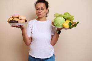Woman Comparing Sweet Doughnuts and Fresh Fruits on Separate Plates photo