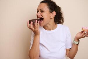 Woman Happily Enjoying Doughnuts in a Playful Pose photo