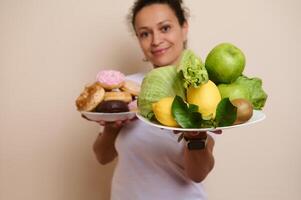 Woman Holding Plates of Fruits and Doughnuts Illustrating Healthy Choices and Indulgence Options photo