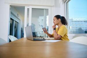 Remote Working Professional Utilizing Technology in Modern Home Office Setting photo