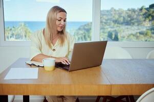 Professional Woman Working Remotely From a Spacious Home Office With Ocean View photo