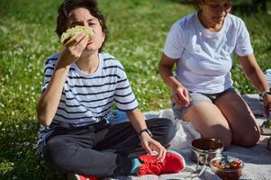 Mother and Child Enjoying a Summer Picnic in Nature photo