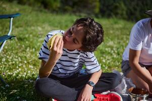 Family Enjoying a Picnic in Nature With Fresh Tacos on a Sunny Day photo