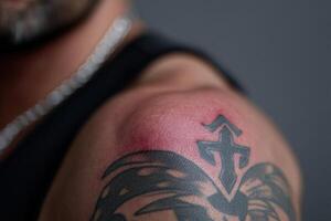 Detailed tattoo design on shoulder with slight irritation after recent application photo