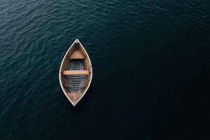 Lonely wooden boat floating on dark waters at twilight photo