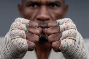 Determined martial artist prepares for competition with wrapped fists in training session photo