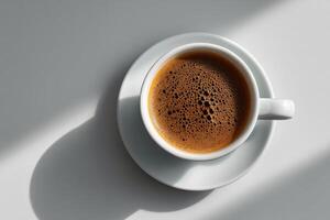 Detailed view of a freshly brewed coffee cup on a white saucer in bright sunlight photo