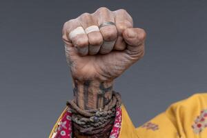 Strong hand gesture representing resilience and determination with detailed adornments photo
