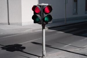 Traffic light displays red and green signals at urban intersection during daylight hours photo