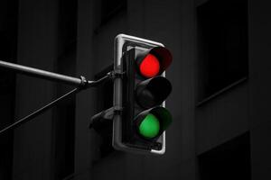Traffic signal changes from red to green at a city intersection during the evening photo
