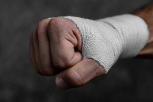 Hand with bandage shows recovery after injury in a dark environment photo