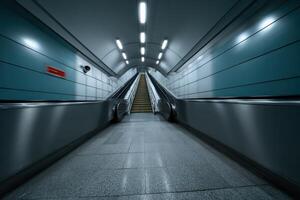Escalator leading to an underground station during early morning hours in a modern city photo