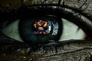 Close-up view showing a human eye reflecting an explosion in its pupil photo