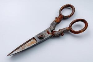 Old dull scissors with bent blades resting on a clean surface photo