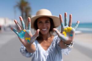 Elegant feminine hands painted with world map under bright sun photo