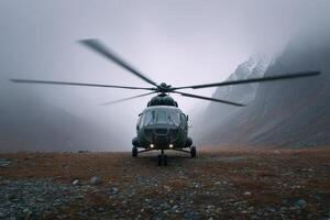 Helicopter blades spin in misty mountain landscape during overcast conditions photo