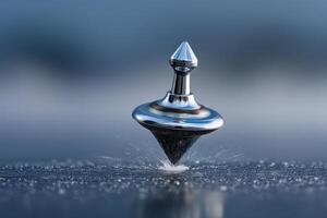 Spinning top rotates gracefully on a smooth surface with water droplets around photo