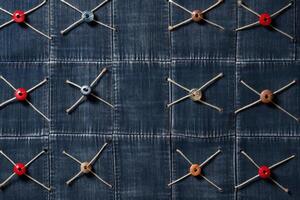 Creative tic-tac-toe game crafted with strings and buttons on denim fabric photo