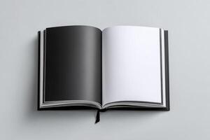 Open book with blank black pages resting on a neutral backdrop during daylight hours photo