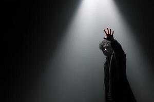 Reaching for the shadow on stage during a captivating performance photo