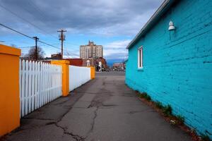 Colorful alleyway showcases unique architecture and urban lifestyle during cloudy weather photo