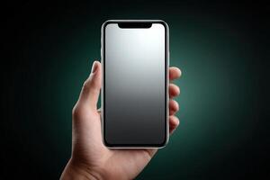 Hand holding a phone with glowing interface at a dark location photo