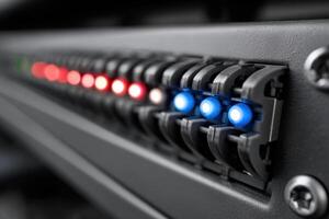 Fiber optic cross-connect shelf displays illuminated ports and signals for network connectivity photo