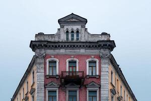 Building design reminiscent of a faded yearbook cover located in a historic urban setting photo