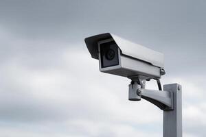 Surveillance camera mounted on pole overlooking the area during cloudy weather conditions photo