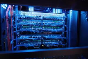 Multiple patch panel connections displayed in a server rack during nighttime operations photo