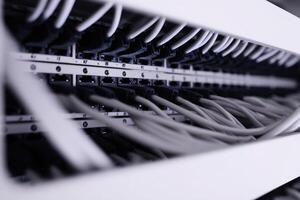 Detailed view of patch panel wiring with hidden cables in a network setup photo